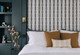Bedroom showing bed with fabric covered wall behind in Chicago fabric. Dark rich painted walls. Design by Kitesgrove